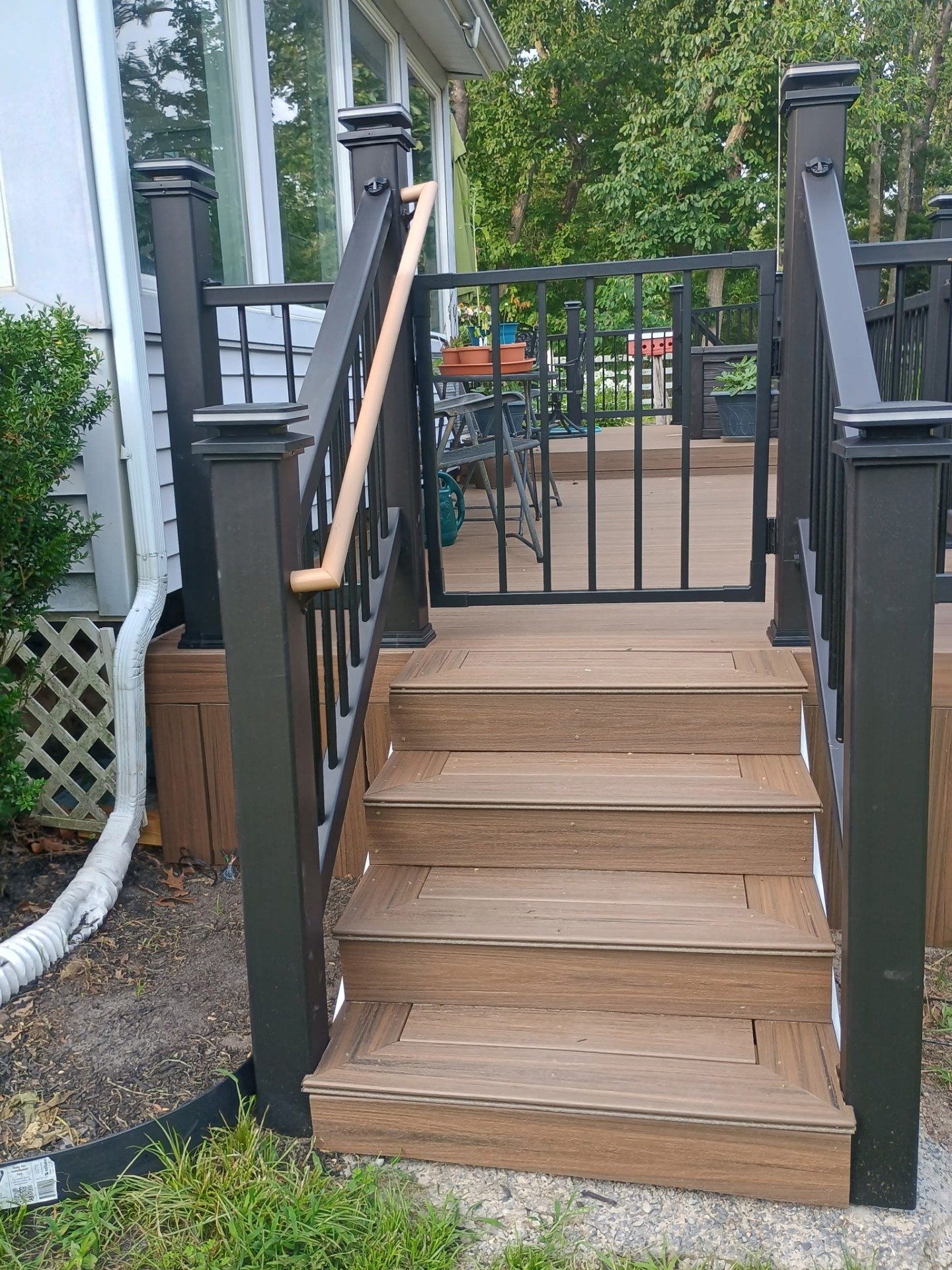 Composite deck stairs with black aluminum railing