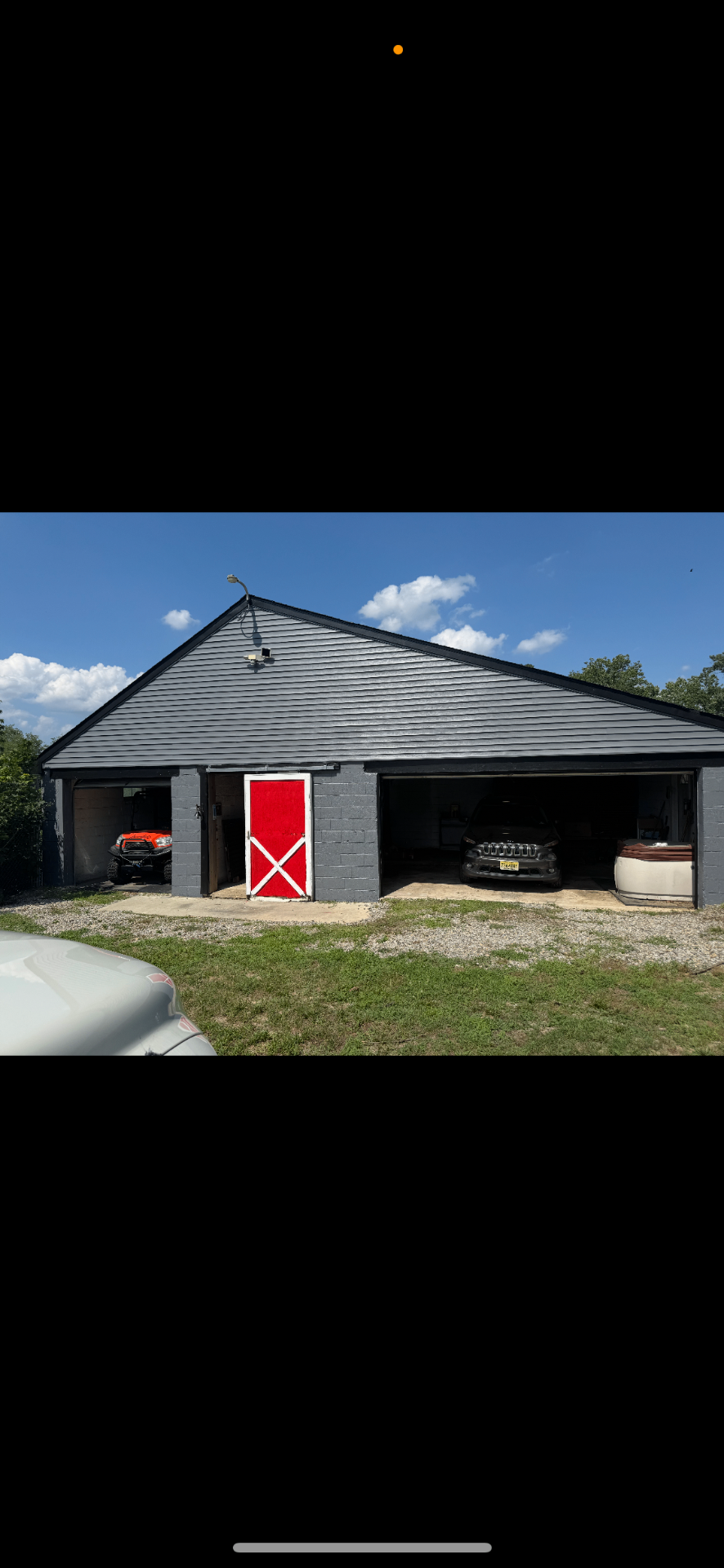Freshly painted workshop with red barn door — work by the hosts